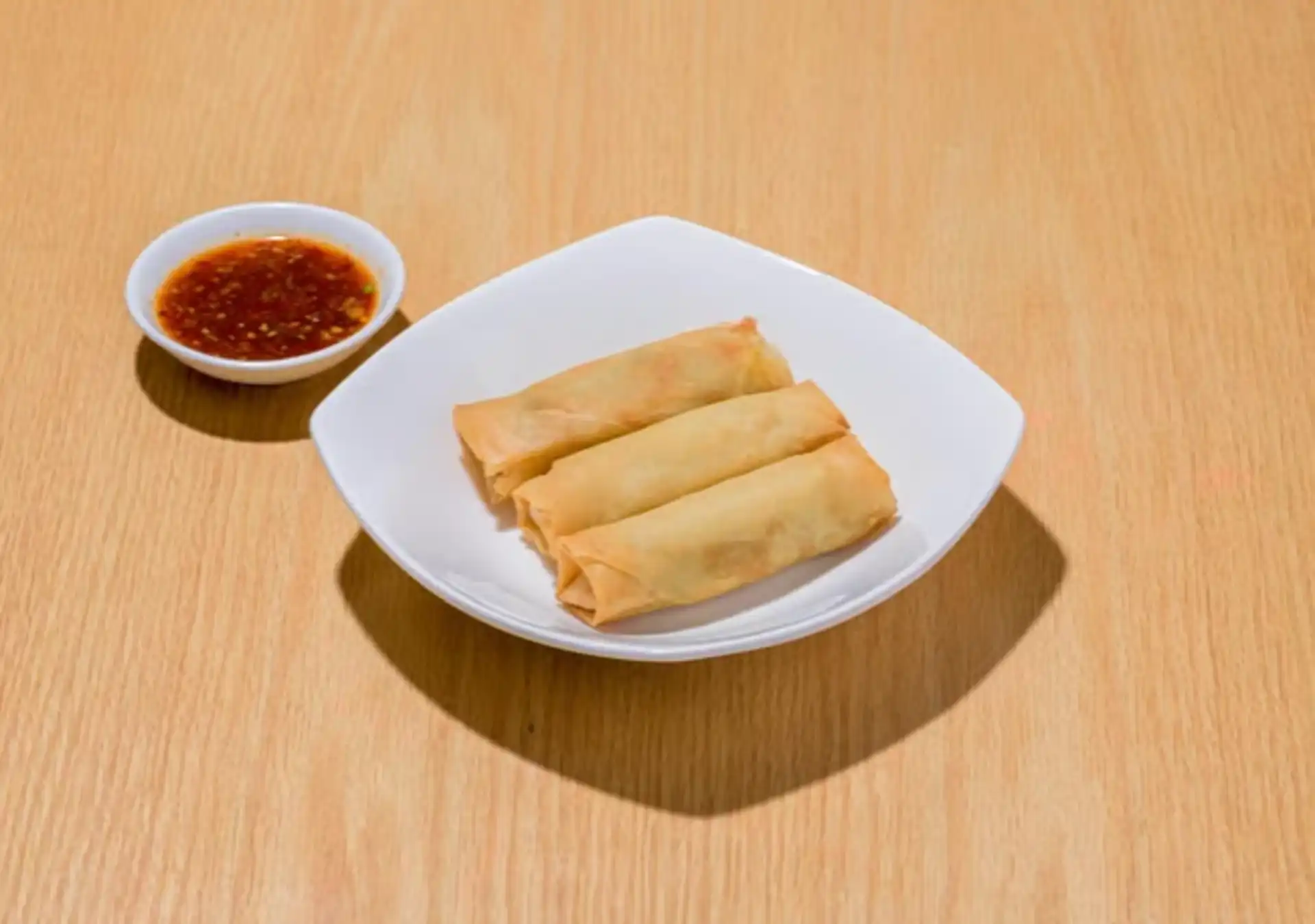 Ugly Dumpling crispy vegetable spring rolls, two pieces on a plate